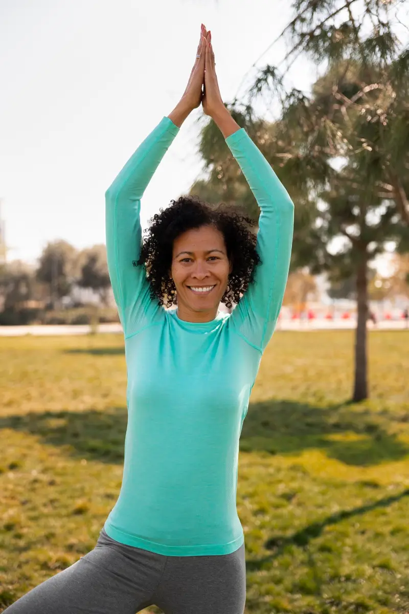 Senior woman doing yoga outdoors in the park